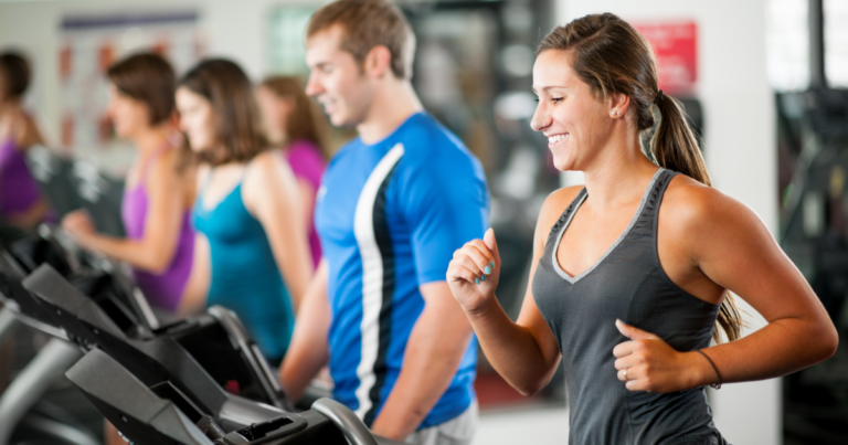 people at gym on treadmills